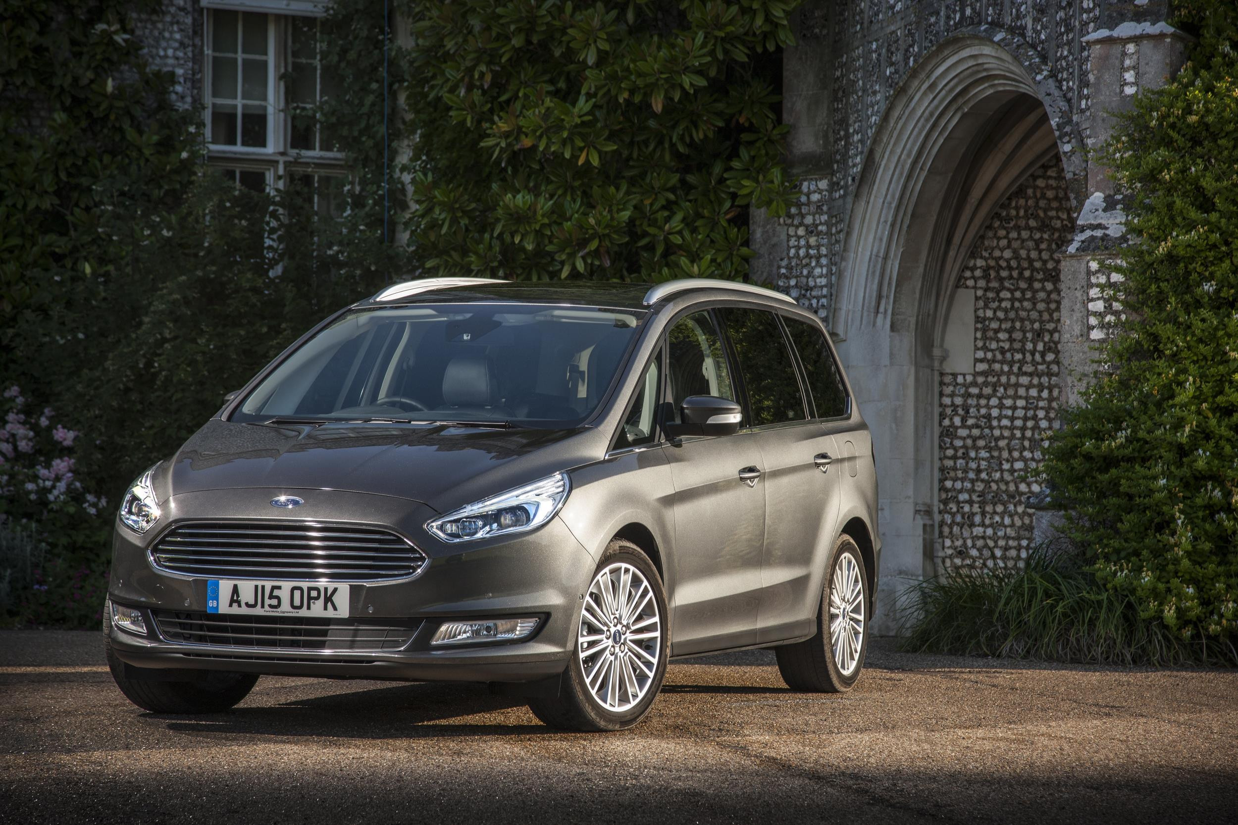 Grey Ford Galaxy parked three-quarters facing left in front of country house.